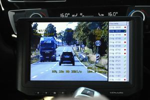 widok z monitora rejestratora w radiowozie, na monitorze widac białe auto