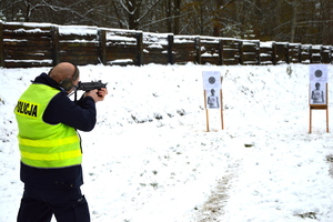 policjant strzelający z broni maszynowej